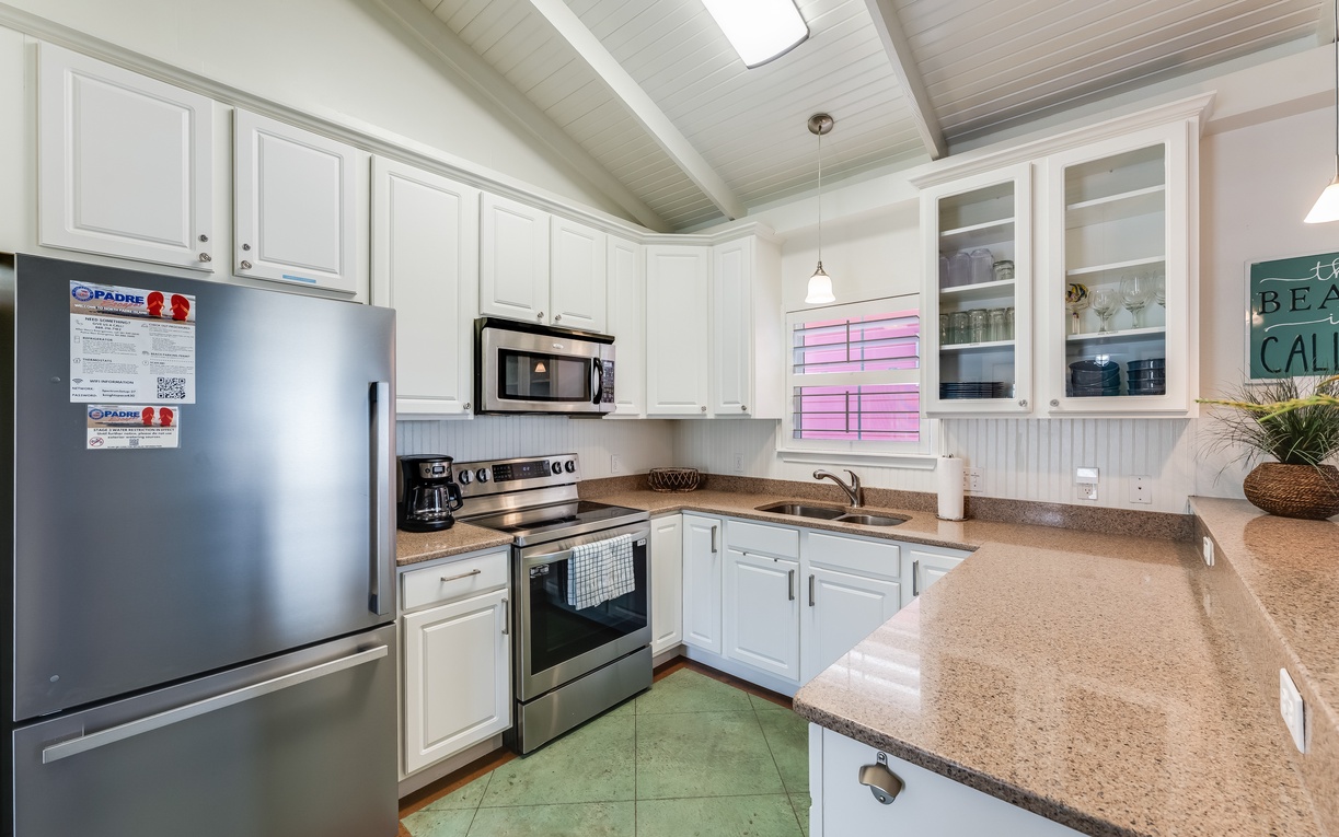 Prepare your favorite meals in this fully-equipped kitchen with stainless steel appliances, granite countertops, and charming coastal details.