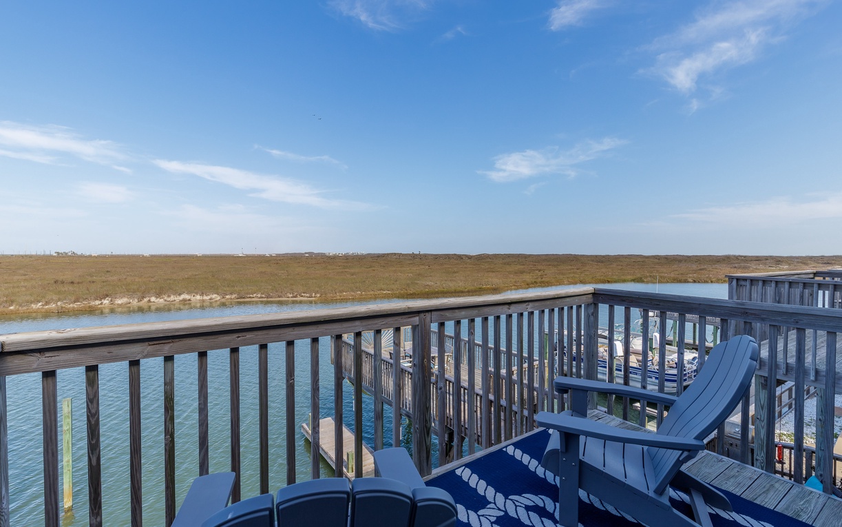 Soak up endless marshland views from your private deck, where comfortable seating invites peaceful mornings with coffee and tranquil evenings watching wildlife.
