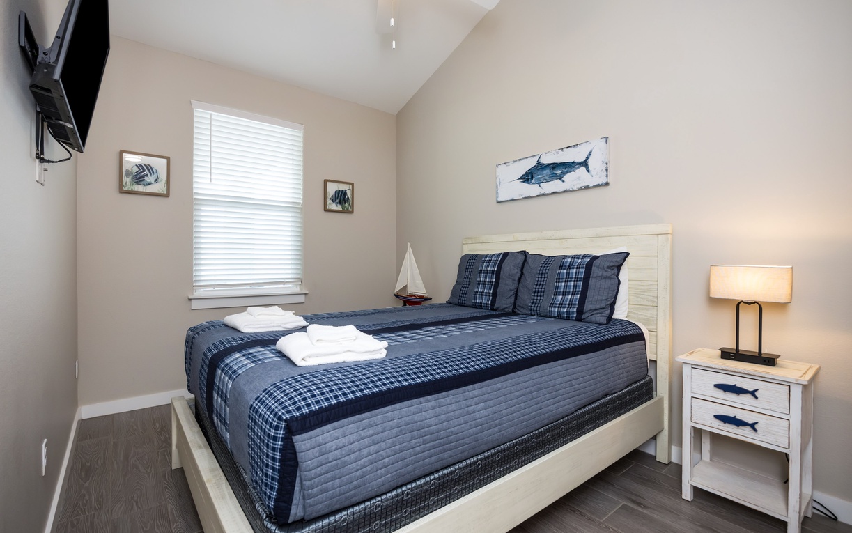 Drift off to sleep in your cozy nautical-themed bedroom, where crisp blue linens and charming coastal artwork create the perfect seaside escape.