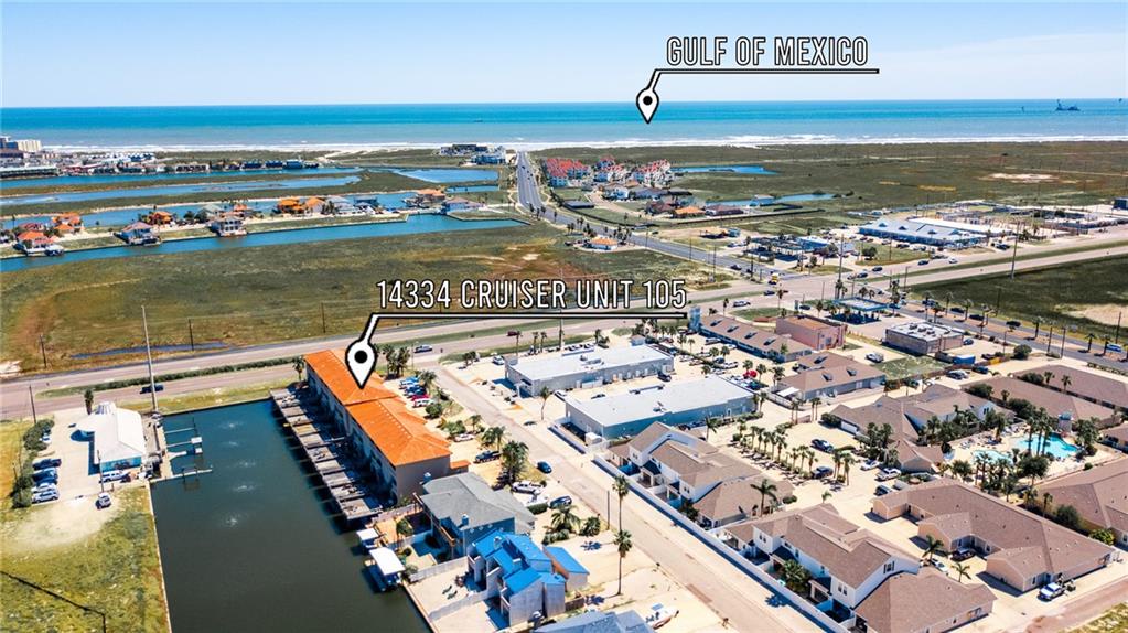 Aerial view of the coastal property and surrounding marina community near the Gulf of Mexico.