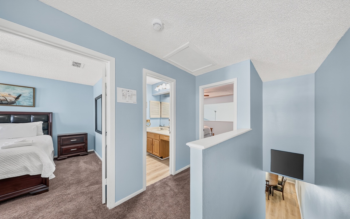 Spacious upper-level retreat with peaceful blue tones connecting your bedroom, en-suite bath, and private sitting area—perfect for unwinding after a day of adventure.