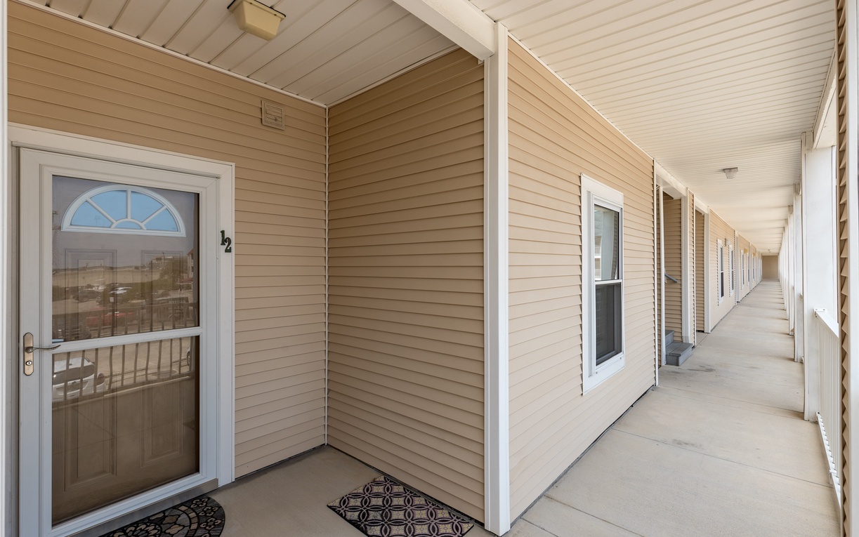 Property building exterior featuring numbered entrance doors along a covered walkway for easy guest access.