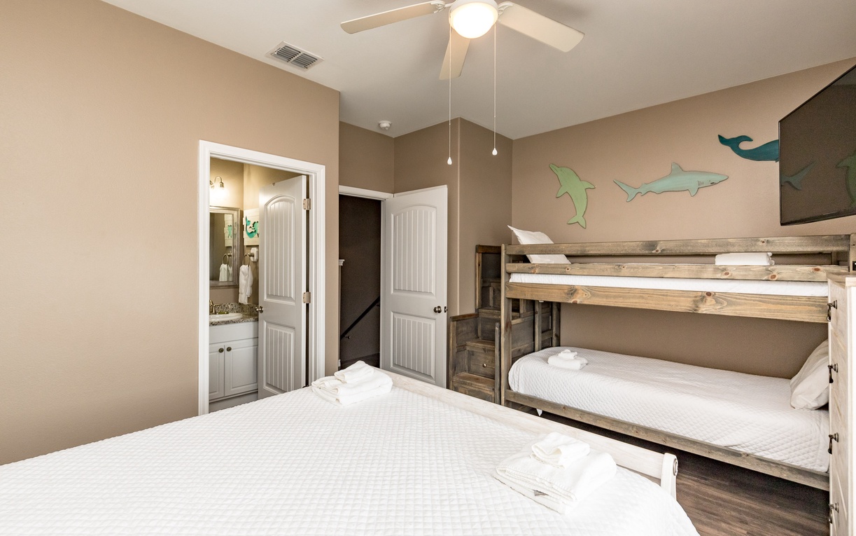 Your cozy bedroom features comfortable beds and fun bunk beds, perfect for families. Fresh towels await your arrival.