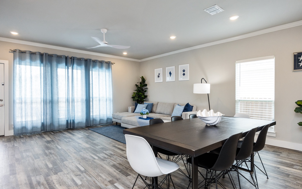 Unwind in your stylish open-plan living space with modern dining for six and a cozy lounge featuring contemporary decor and natural light.