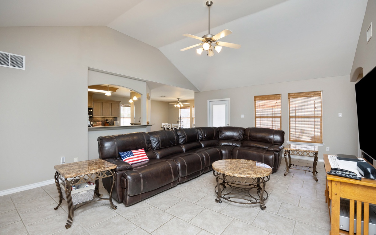 Sink into the plush leather sectional and enjoy your favorite shows on the big screen TV in this spacious living room.
