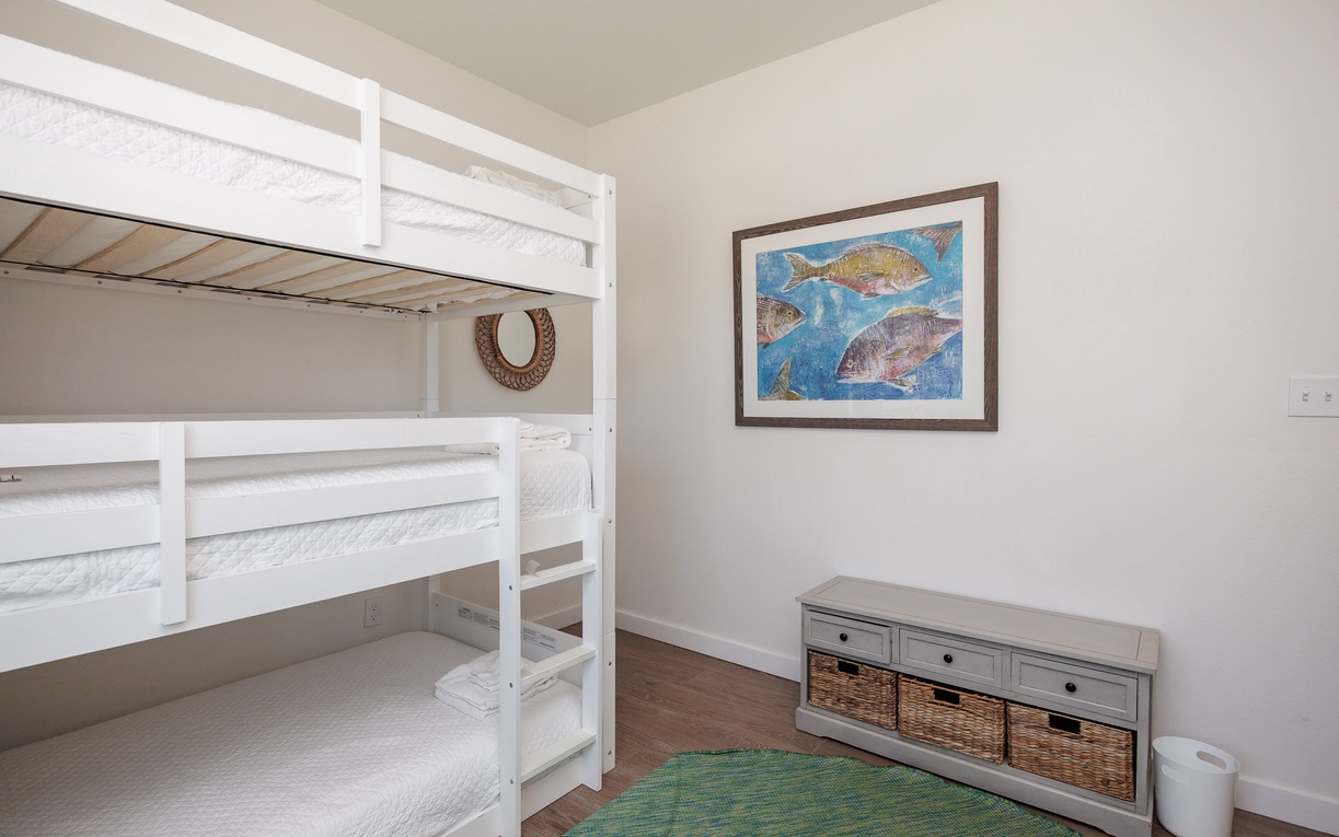 Perfect for kids or groups, your cozy bunk bed room features crisp white linens and charming coastal artwork that sets a peaceful tone.