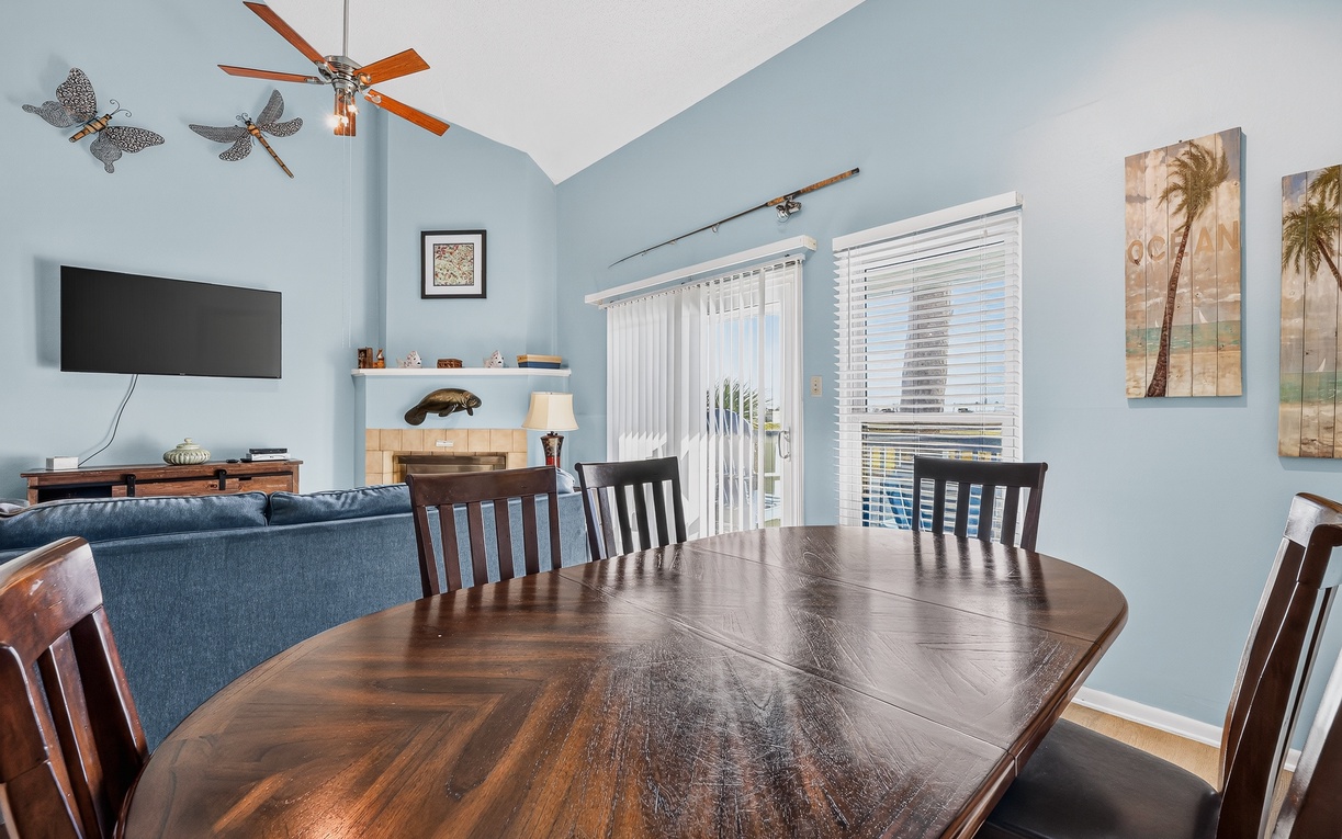 Gather around the beautiful wooden dining table for delicious meals, morning coffee, or family game nights while enjoying the bright, open living space and natural light.