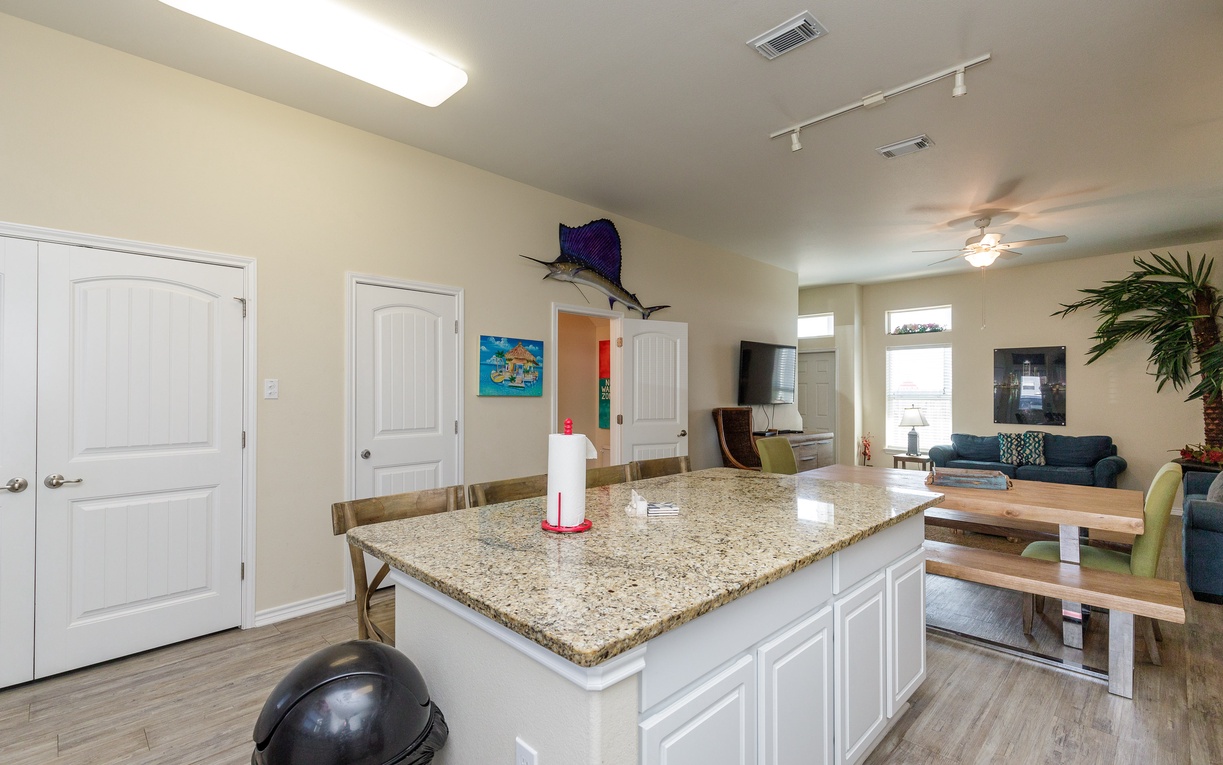 Your spacious kitchen island becomes the heart of your vacation, perfect for preparing meals and gathering with loved ones in this bright, welcoming space.