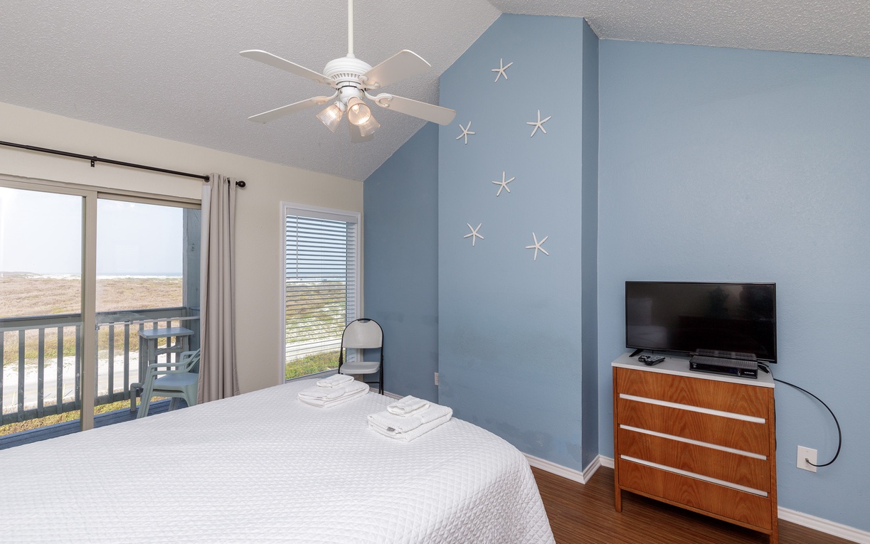 Your coastal-themed primary bedroom features a queen size bed, private balcony, and ensuite bathroom.