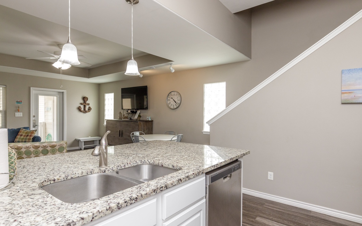 Your open kitchen island flows into the living area, perfect for morning coffee or entertaining guests in this bright, modern space.