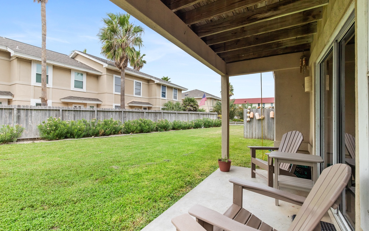 Relax in your covered patio with comfortable seating overlooking a spacious private backyard, perfect for morning coffee or evening unwinding.