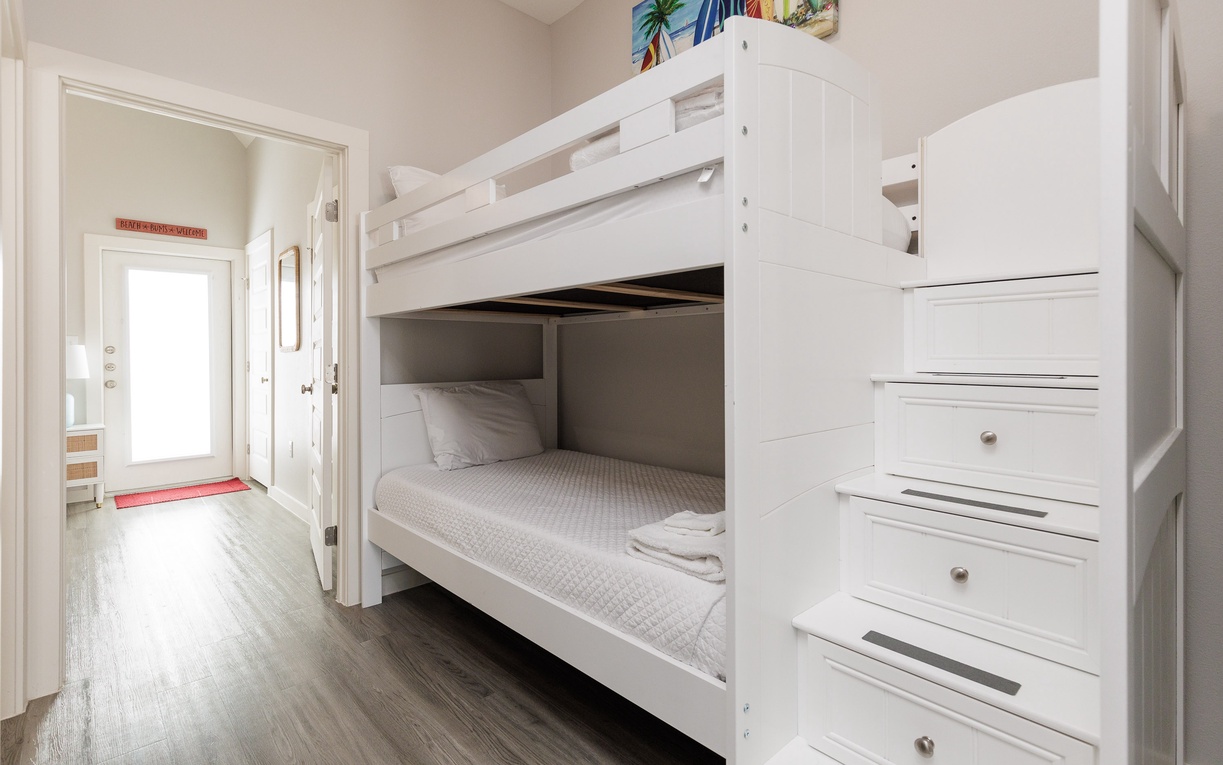 Your cozy bunk bed retreat features built-in storage stairs and crisp linens, perfect for families or friends sharing memories.