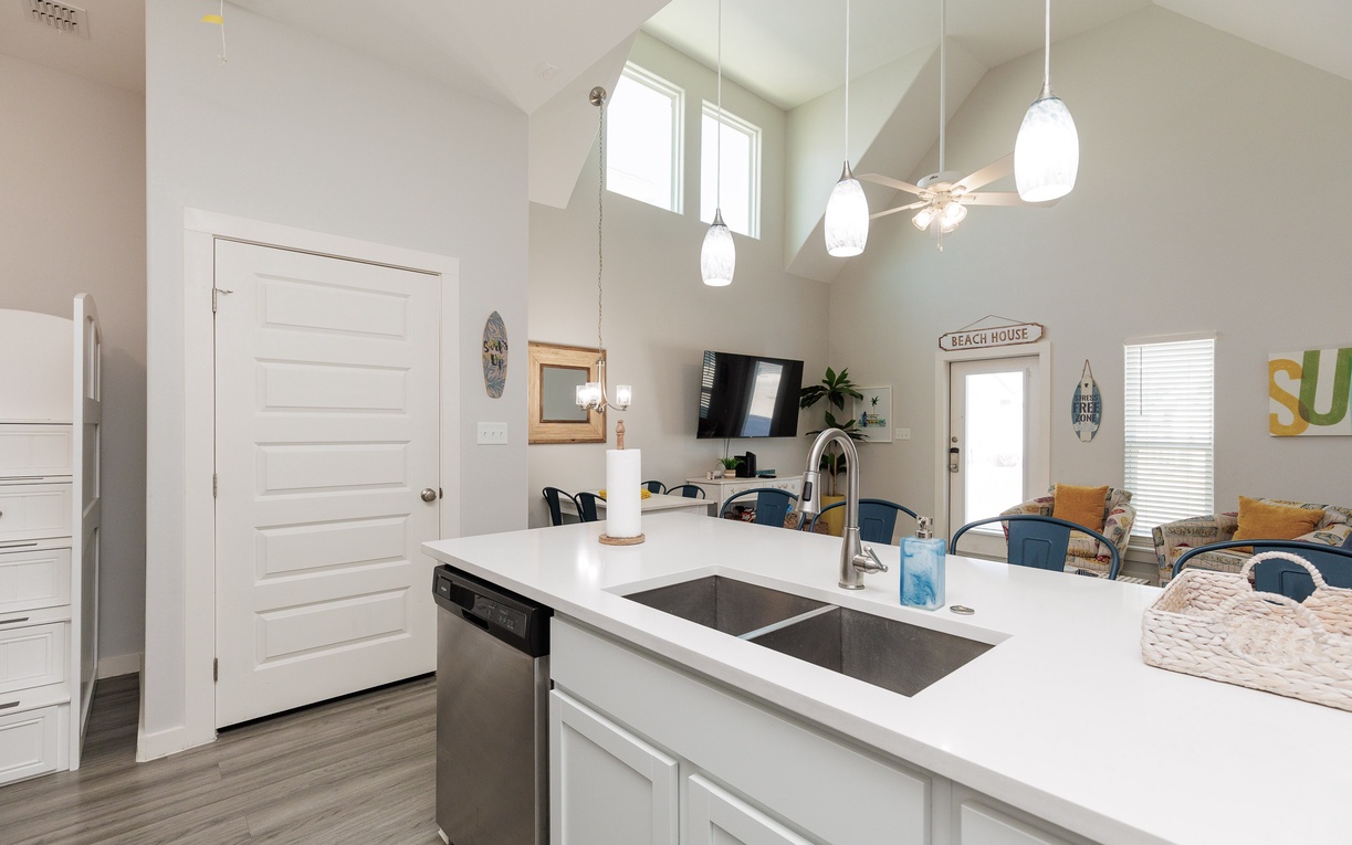 Your bright kitchen island becomes the heart of beach memories, with gleaming countertops and modern appliances ready for coastal gatherings.