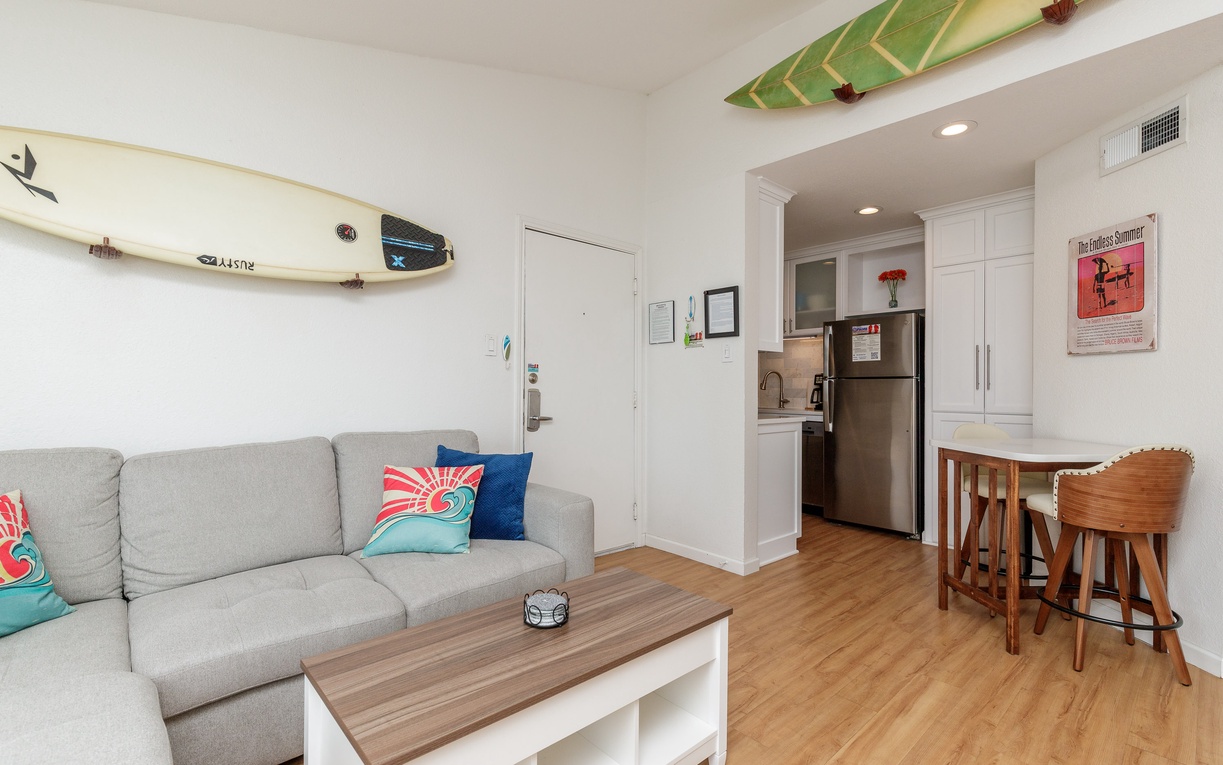 Relax in your bright, surf-inspired space where colorful paddleboards adorn the ceiling and coastal vibes meet modern comfort throughout.
