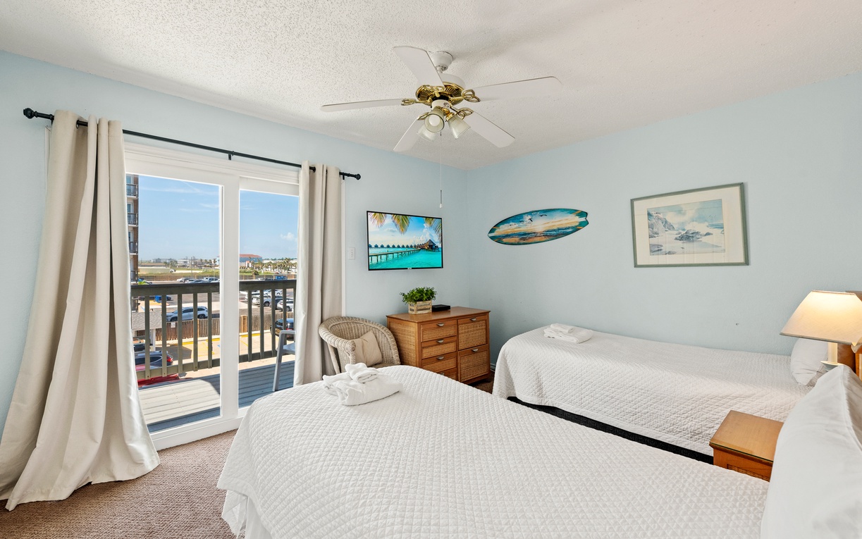 Unwind in this bright coastal bedroom featuring two twin beds and easy access to the private balcony—perfect for enjoying the fresh coastal breeze.