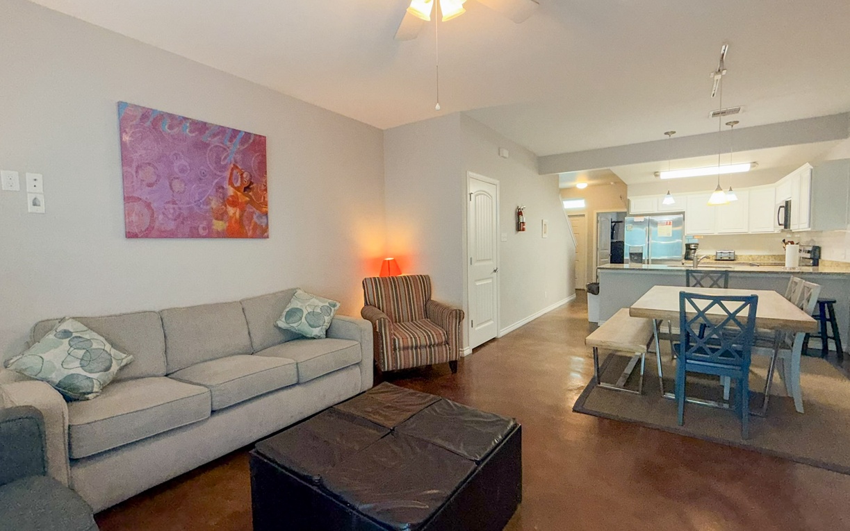 Settle into your bright, modern living space where comfort meets style—spacious sofa, stylish dining area, and open kitchen await your arrival.