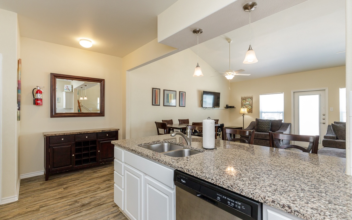 Your open kitchen flows seamlessly into elegant living spaces, perfect for cooking and entertaining with granite counters and modern appliances.