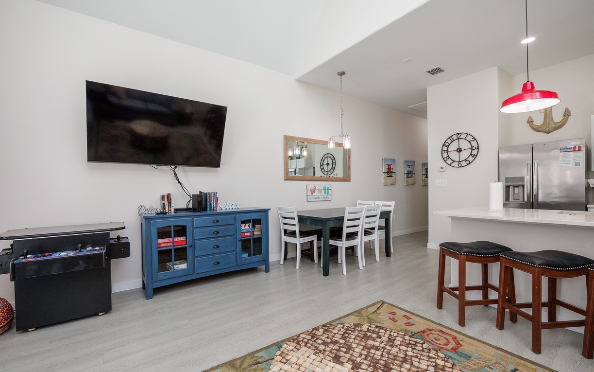 Your spacious living area combines comfort with coastal charm. Relax on the soft rug while enjoying your favorite shows on the large TV.