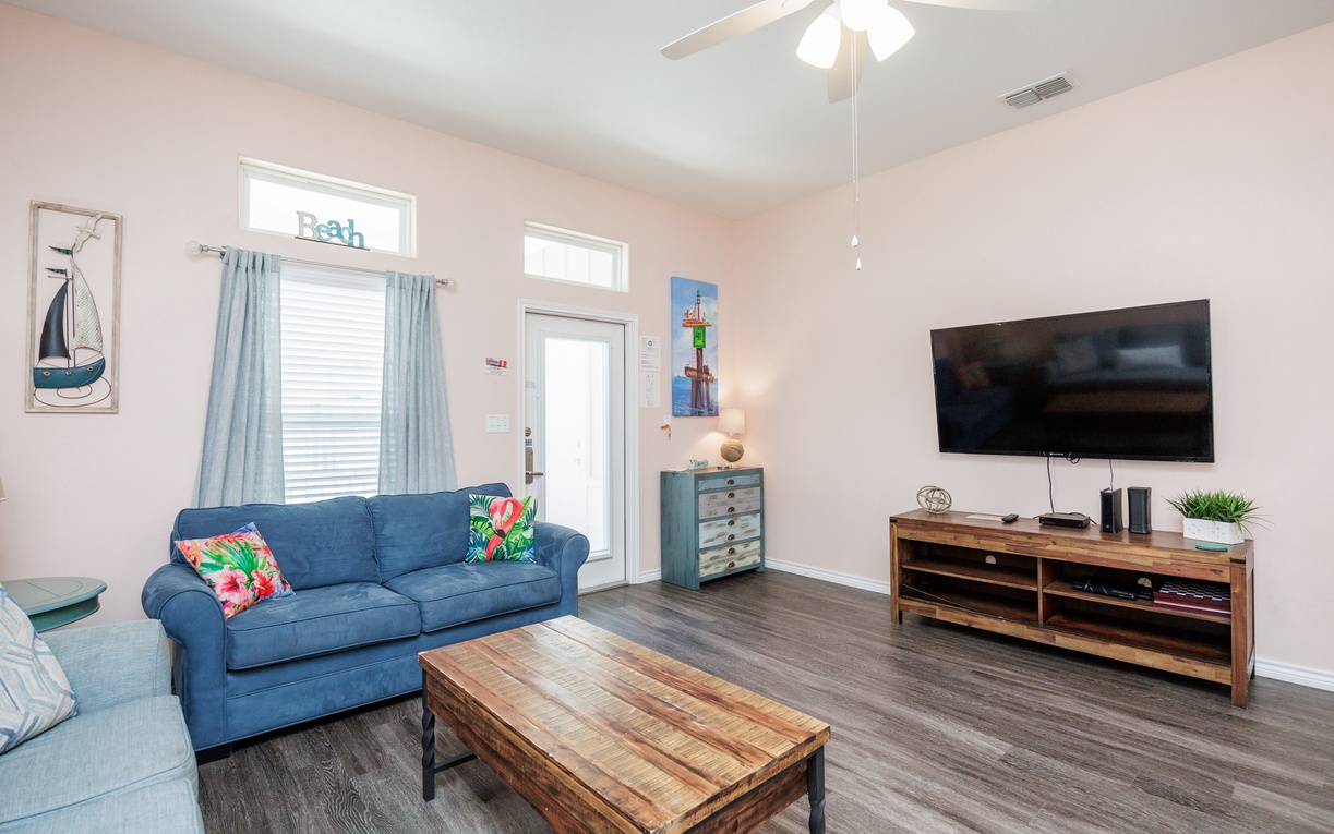Sink into plush sofas with tropical accents while you enjoy your favorite shows on the large TV in this bright, airy living space.