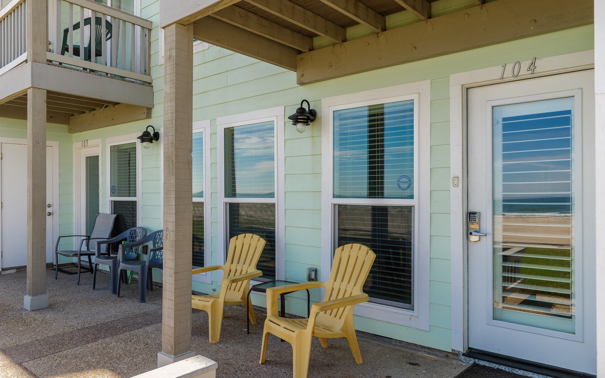 Your beachfront escape features a covered patio with ocean views where you can unwind in colorful chairs just steps from the sand.