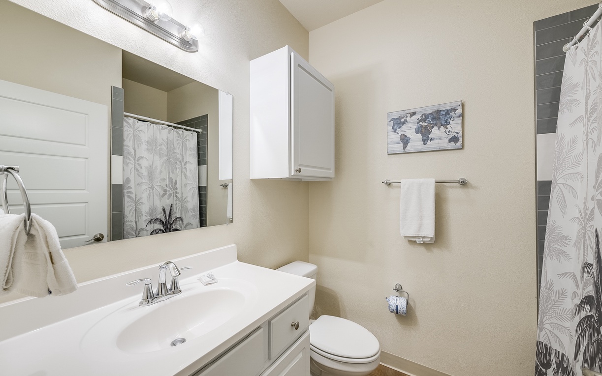 Your private bathroom features modern amenities with fresh towels and tropical-inspired décor to help you unwind after your adventures.