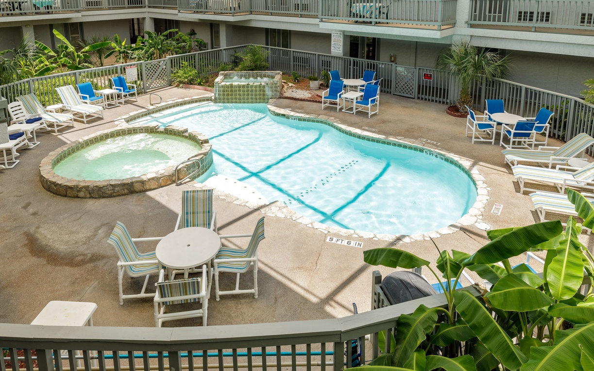 Soak up sunshine at your private pool oasis, where comfortable loungers and tropical plants create the perfect spot to unwind.