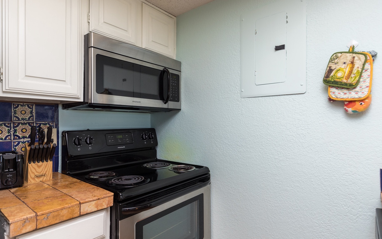 Your fully equipped kitchen awaits with modern appliances and cheerful tile accents, perfect for preparing memorable meals during your stay.