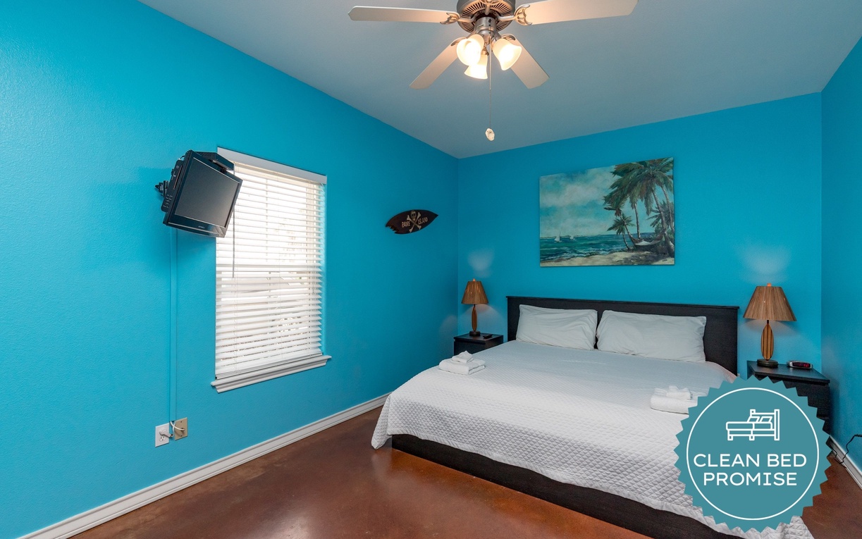 Drift off to dreamland in this ocean-inspired bedroom where turquoise walls and tropical art transport you to paradise.