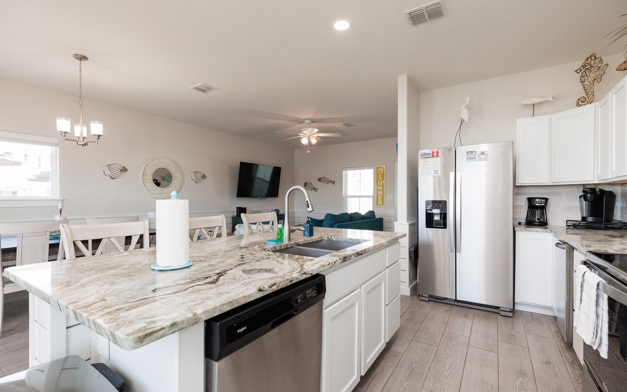 Your spacious kitchen features marble countertops, stainless appliances, and an island perfect for morning coffee or meal prep together.
