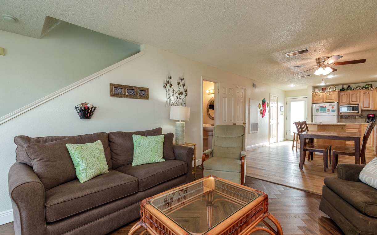 Relax in your spacious living room with comfy seating, then gather around the dining table for meals in this bright, open-concept home.