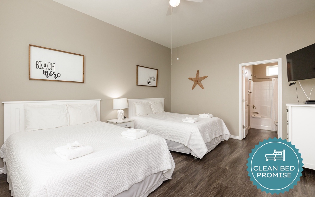 Drift off in this bright twin bedroom featuring crisp linens and beach-inspired charm. Your peaceful retreat includes a ceiling fan for comfort.