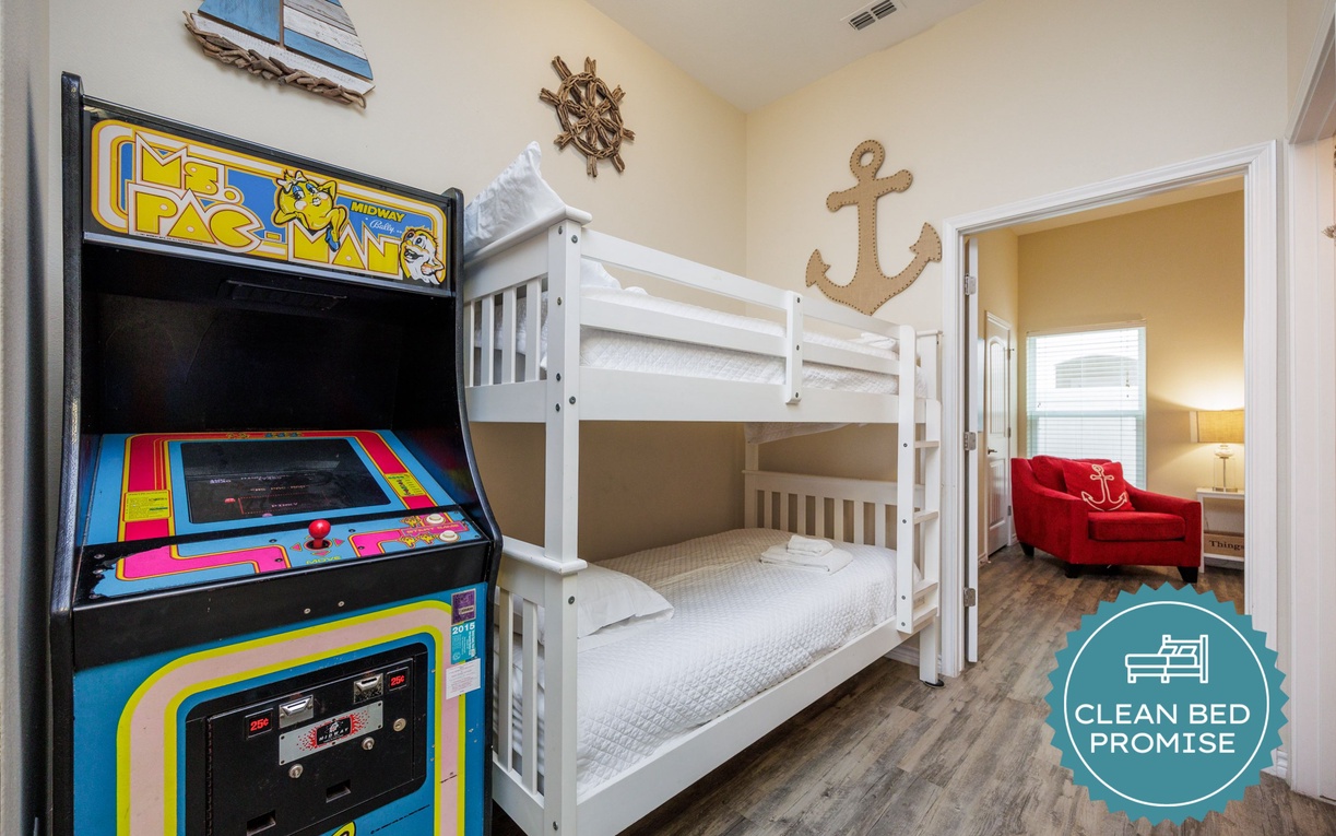Your little sailors will love this nautical-themed room with bunk beds and classic arcade games for endless fun.