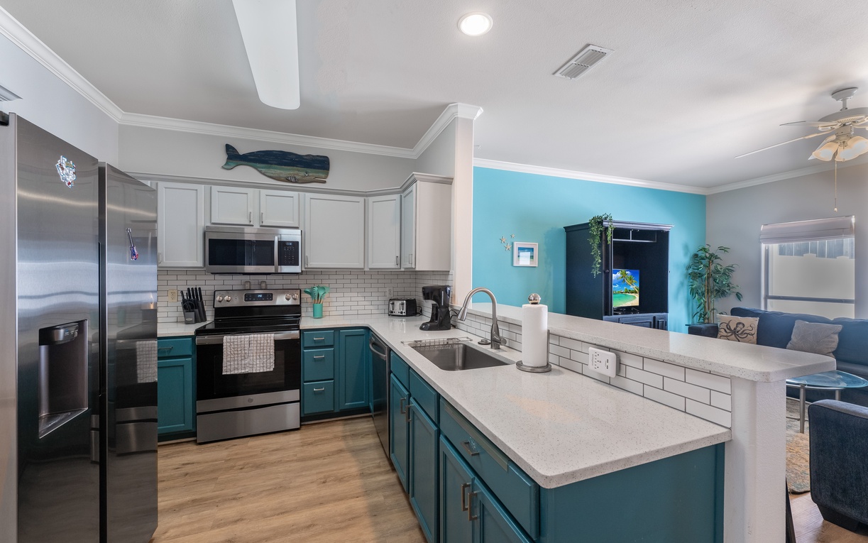 Your bright, fully-equipped kitchen awaits with modern appliances and coastal charm for memorable meal prep.