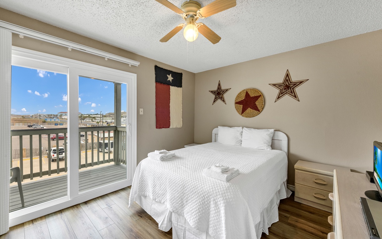 Drift off in your Texas-themed bedroom with crisp white linens and western star decor, while gentle gulf breezes flow through your private balcony doors.
