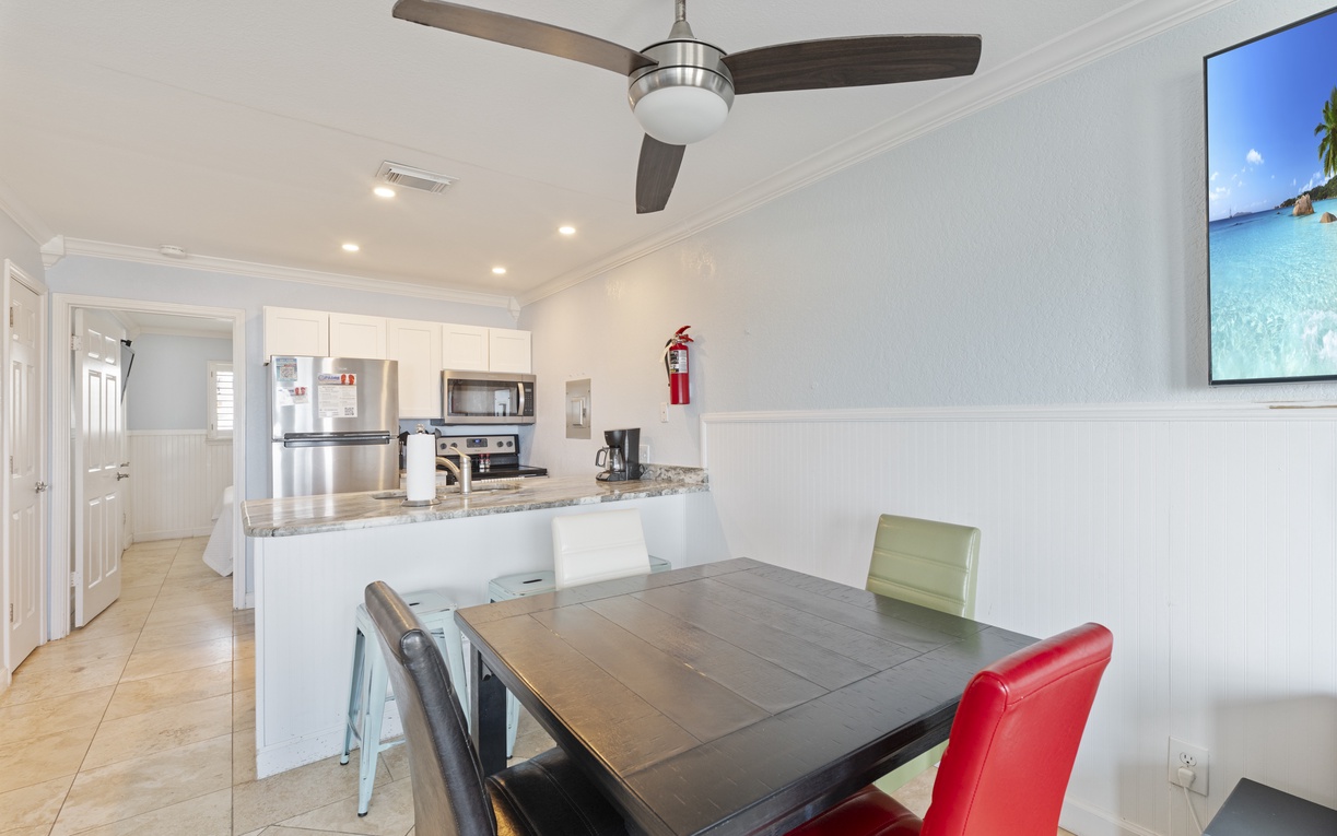 Your open-concept living space features a sleek kitchen and dining area, perfect for preparing meals and gathering together.