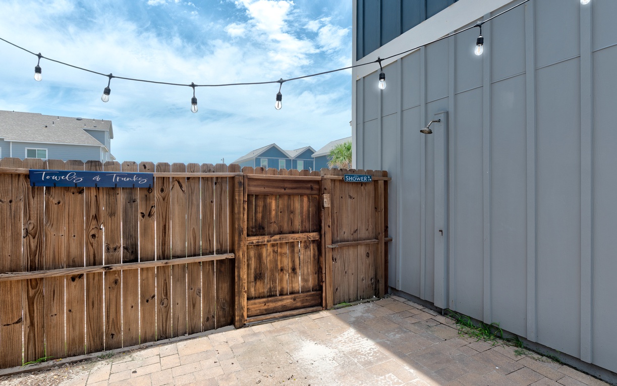 Outdoor shower off the patio space for extra convenience rinsing off after the beach.