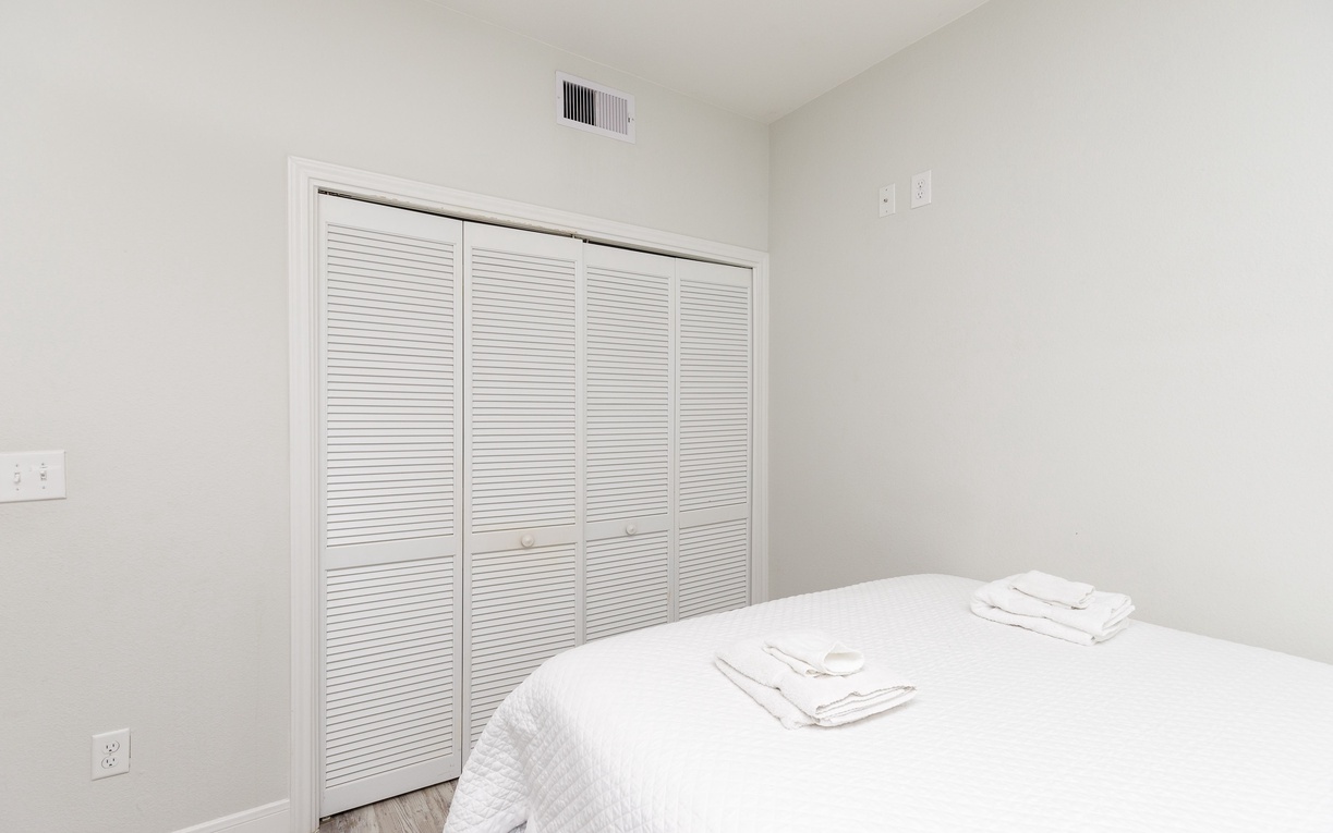 Unwind in your serene bedroom with crisp white linens, generous closet space, and climate-controlled comfort for restful nights.