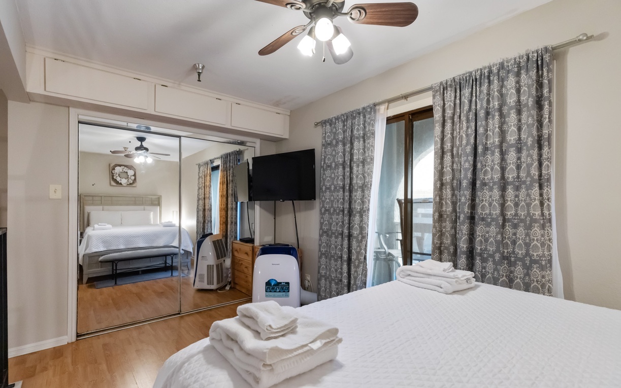 Your comfortable bedroom features crisp linens, a ceiling fan for perfect temperature, and mirrored closets that make the space feel larger.