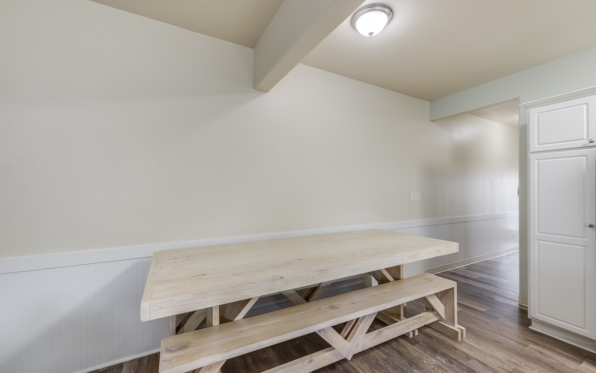 Your private dining space features a beautiful rustic wood table with matching benches, perfect for family meals and game nights.