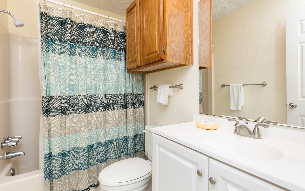 Your private bathroom features a relaxing tub-shower combo with fresh towels and thoughtful amenities, making your morning routine feel effortless and refreshing.