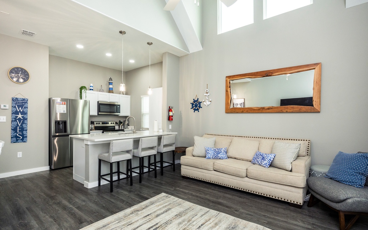 Relax in your bright, open-concept living space with soaring ceilings, modern kitchen, and coastal touches throughout.