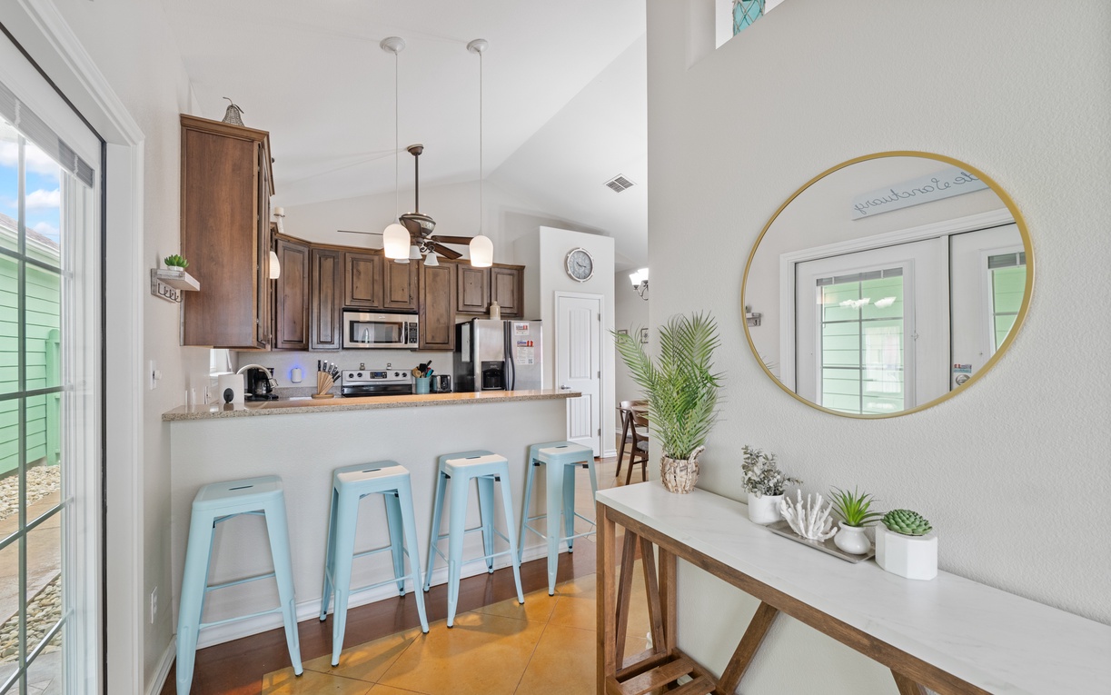 Gather with friends at your stylish breakfast bar, surrounded by coastal touches and warm wood finishes that make meal prep a joy.