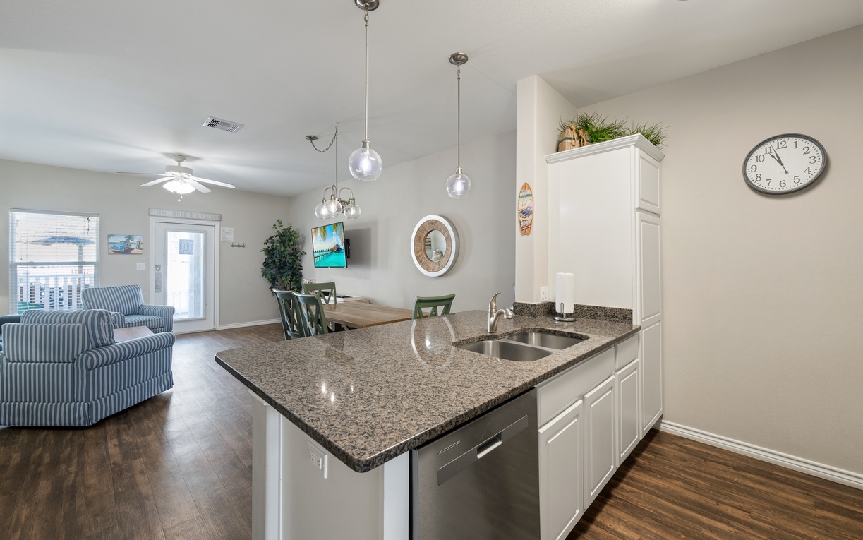 Your open-concept kitchen and living space flows seamlessly with natural light and coastal charm, perfect for gathering together over home-cooked meals and making lasting vacation memories.