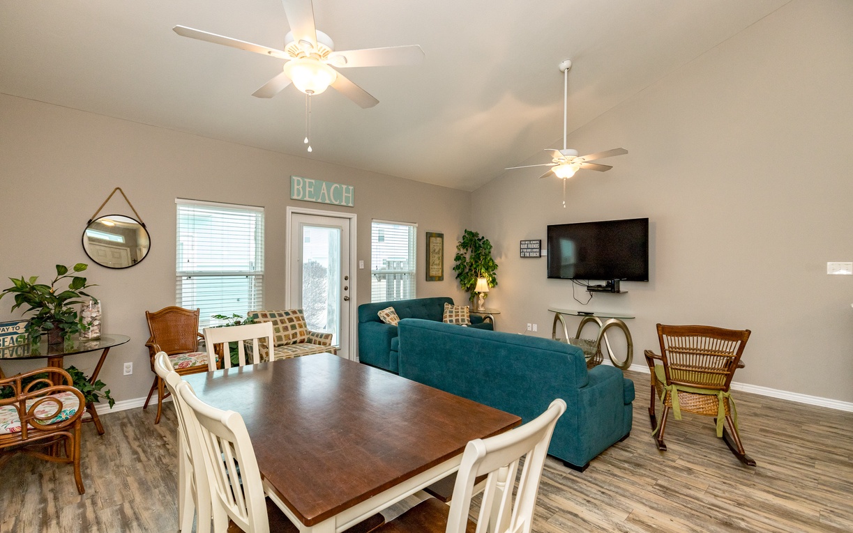 Relax in your bright, beachy living space where coastal vibes meet comfort with cozy seating and dining for memorable meals.
