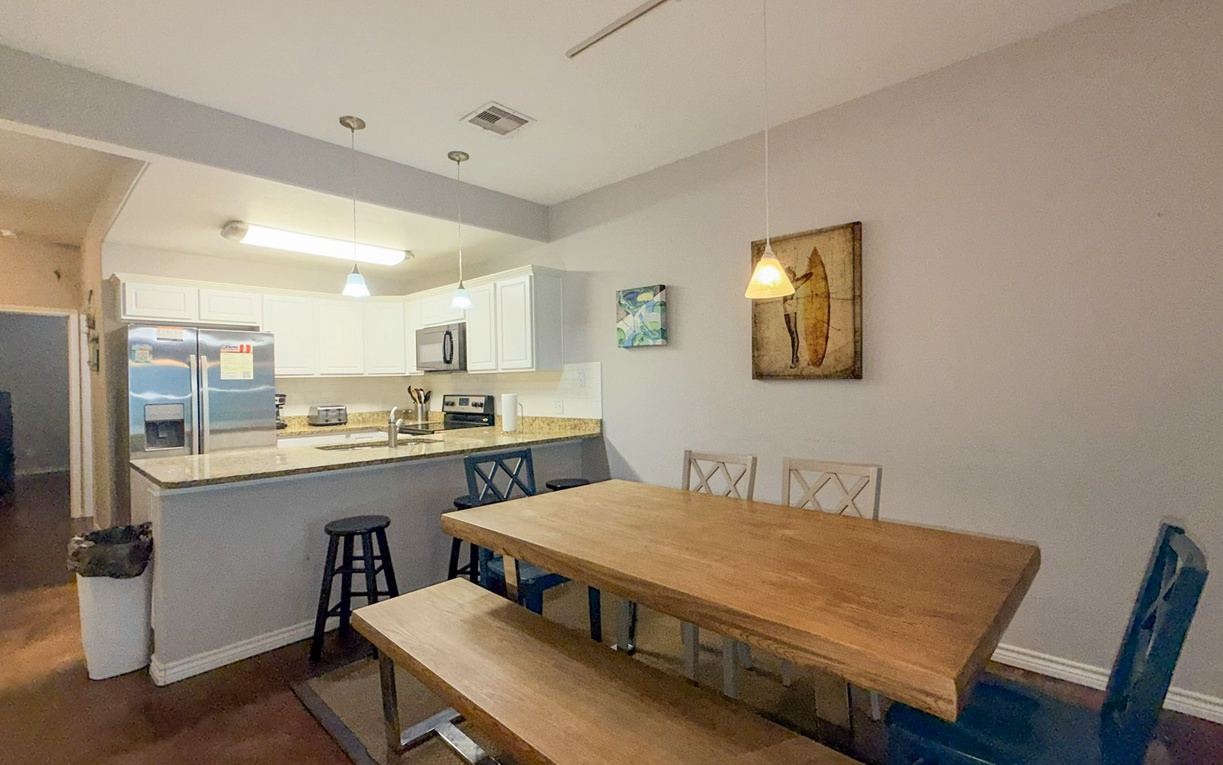 Gather around your spacious dining table where memorable meals and conversations unfold, perfectly connected to your fully-equipped kitchen.