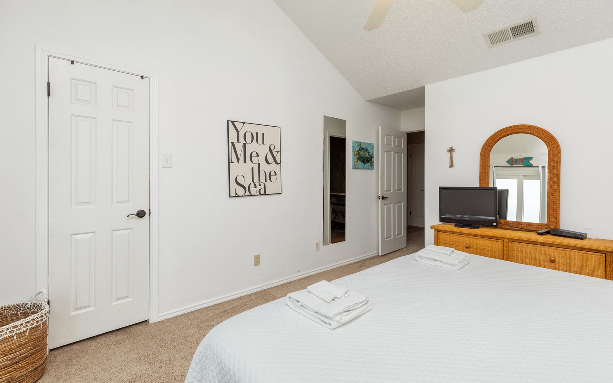 Unwind in your peaceful bedroom with coastal charm, featuring a comfortable bed, warm wicker accents, and thoughtful touches that make you feel instantly at home.