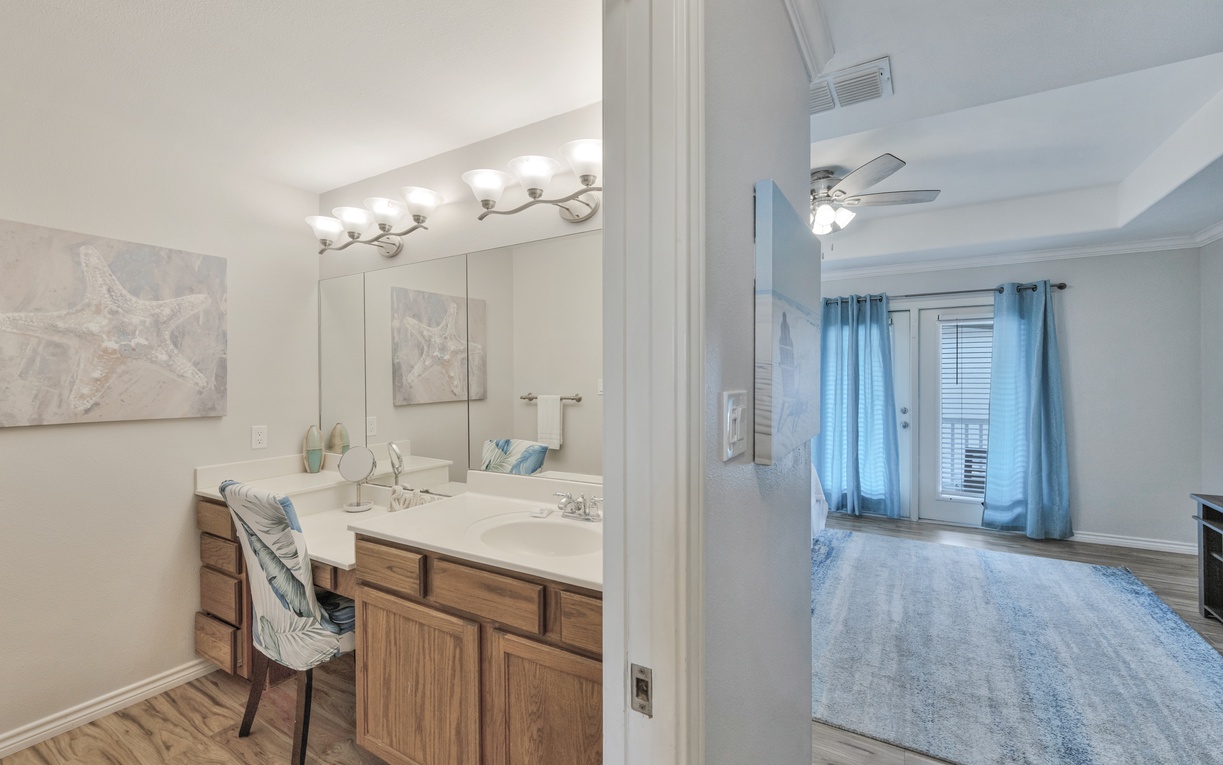 Your private bathroom vanity offers dual sinks and ample counter space, perfectly positioned beside your spacious bedroom retreat.
