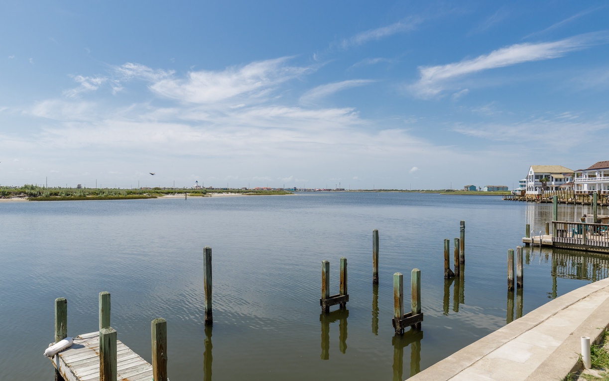 Peaceful waterfront setting with private dock access and serene bay views stretching to the horizon.