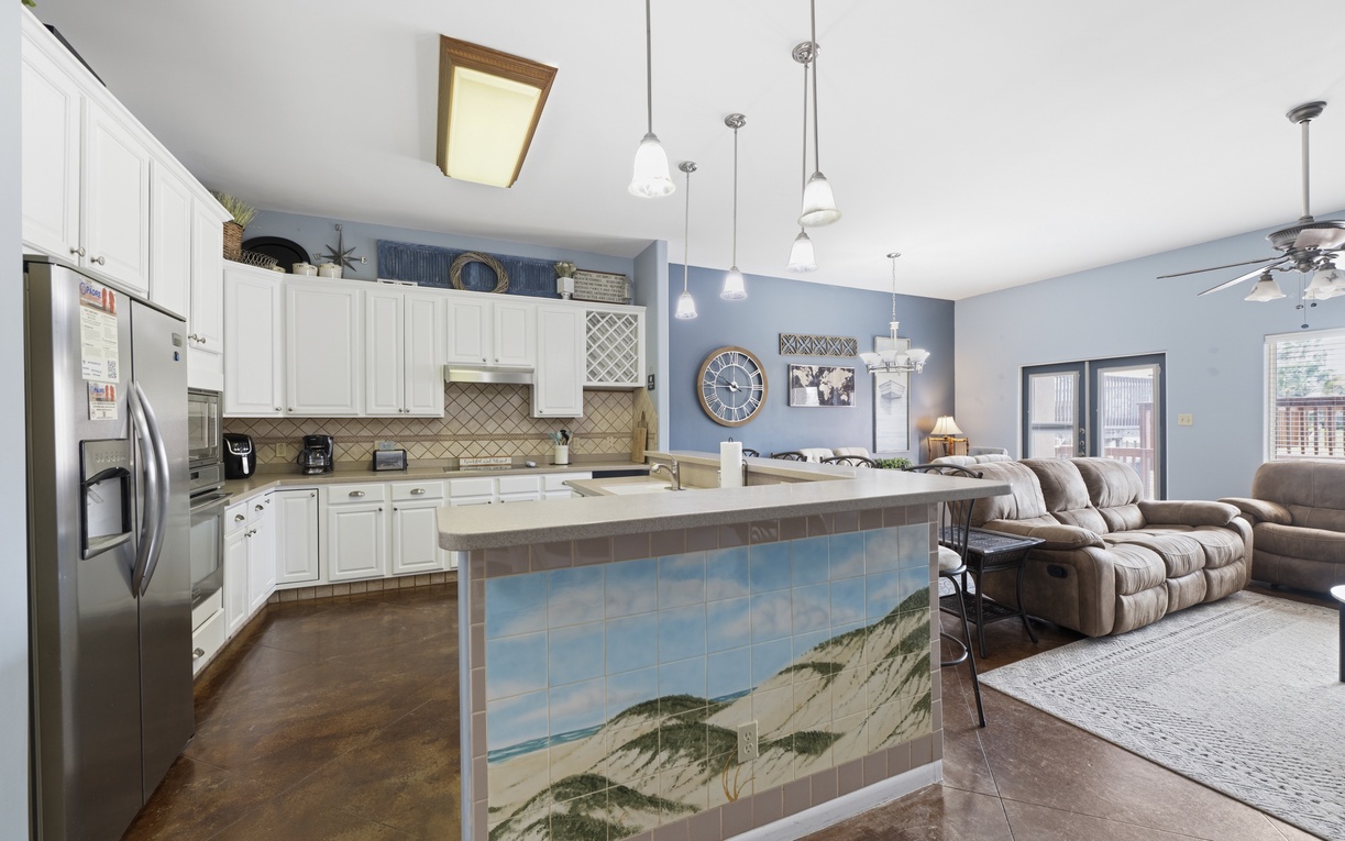 Gather, cook, and relax in this open-concept space where your fully equipped kitchen flows seamlessly into a welcoming living area—perfect for effortless entertaining and togetherness.