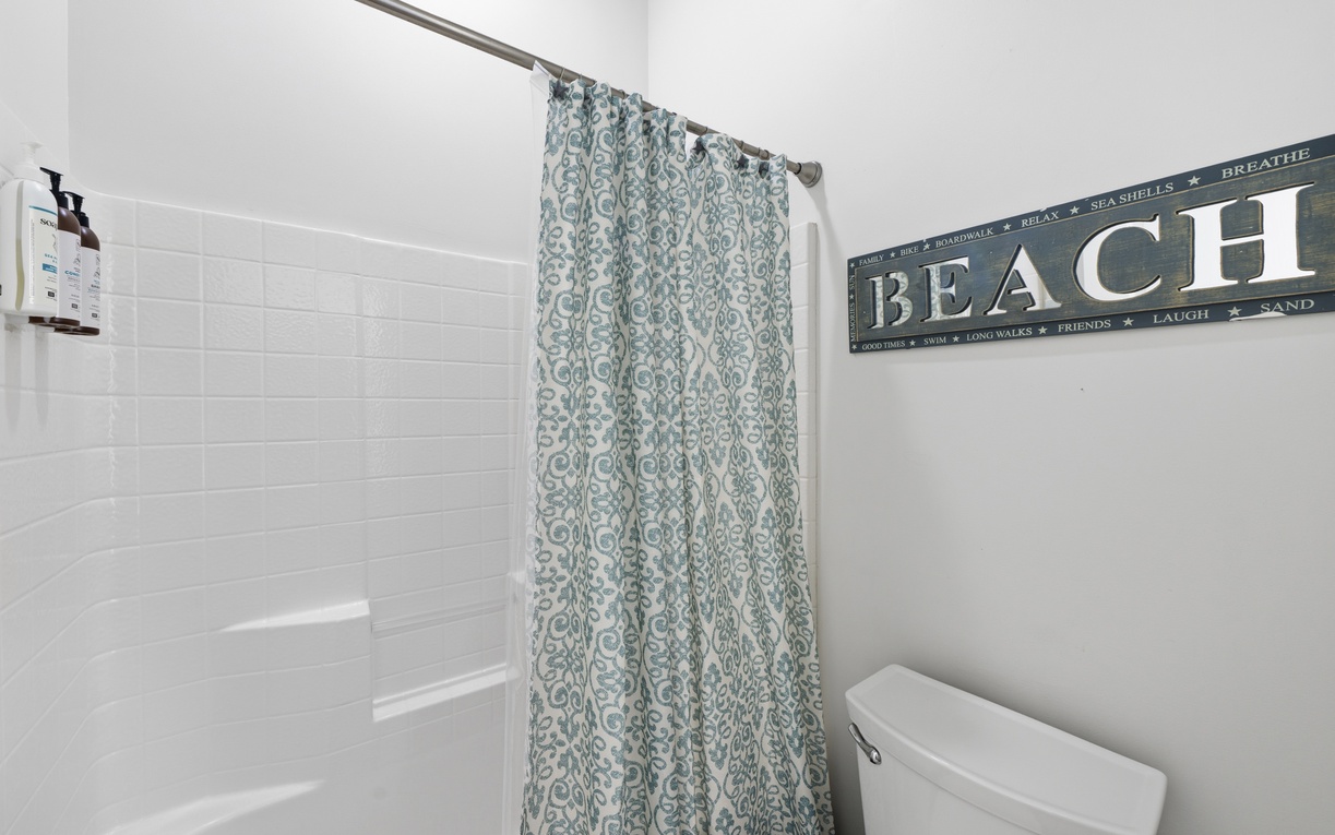 Freshen up in your private bathroom with coastal decor that invites you to relax and unwind after a day by the shore.